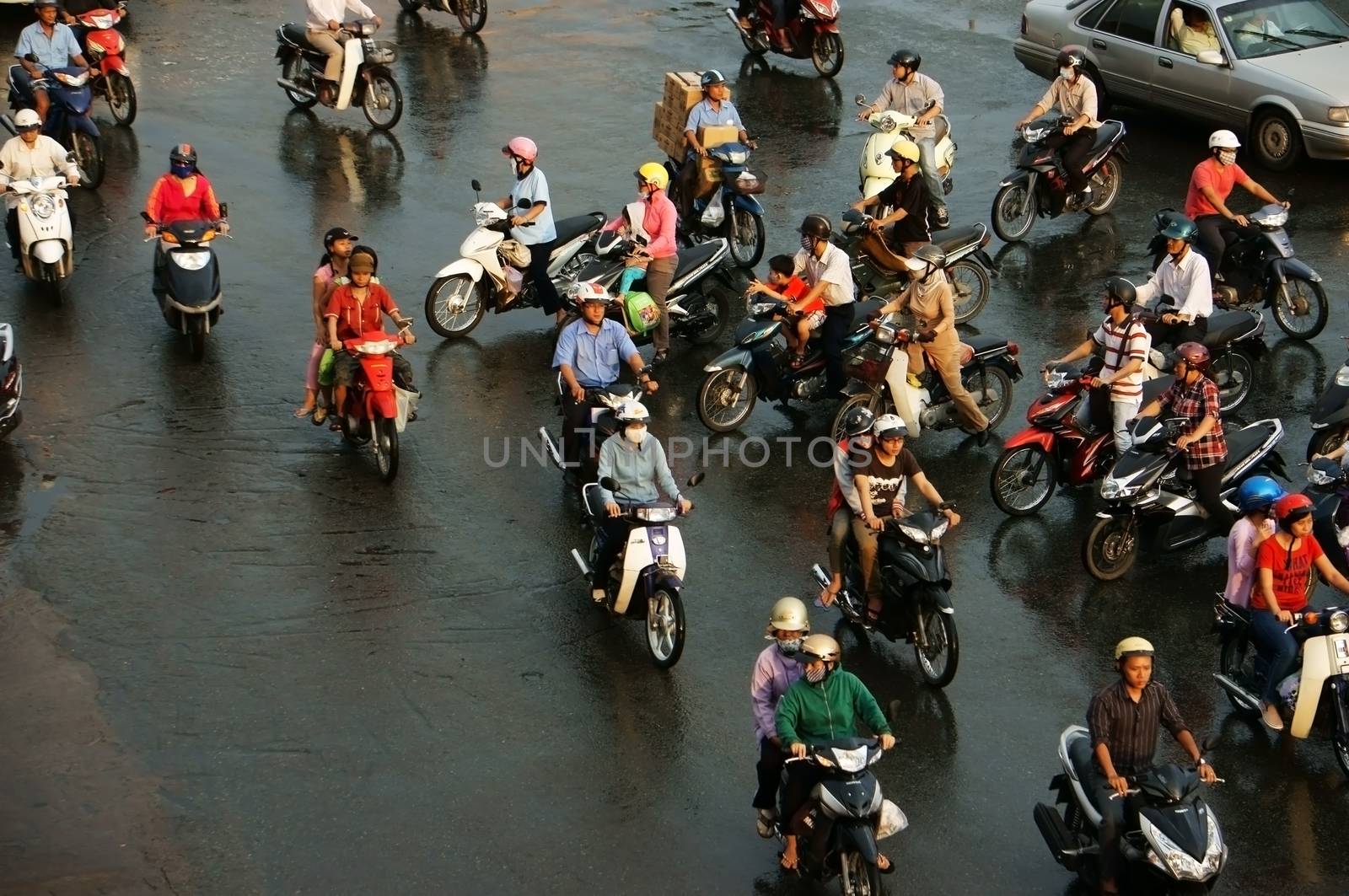 HO CHI MINH, VIET NAM, ASIA- NOV 22: Group of people wear helmet, ride motorbike moving on street in rush hour, they pass by make chaotic traffice in Ho Chi Minh city, Vietnam, Asia on Dec 15, 2012
