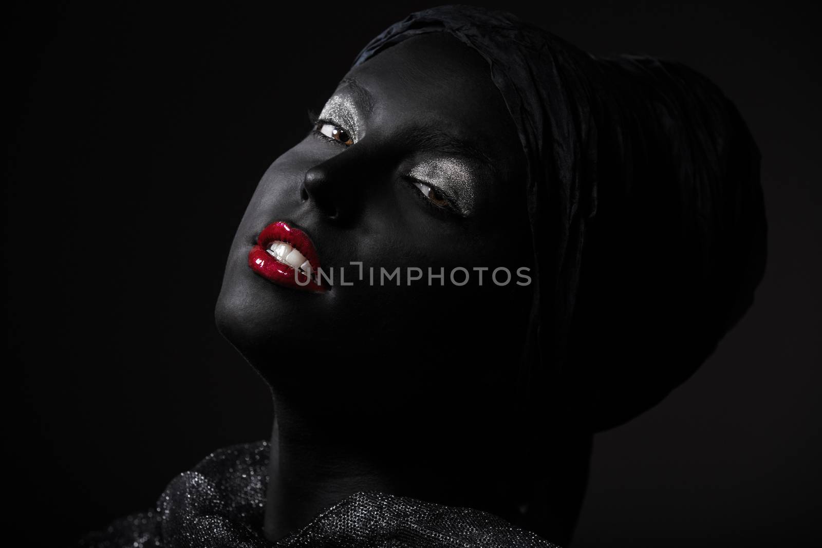 Woman with black skin in traditional turban. Studio shot