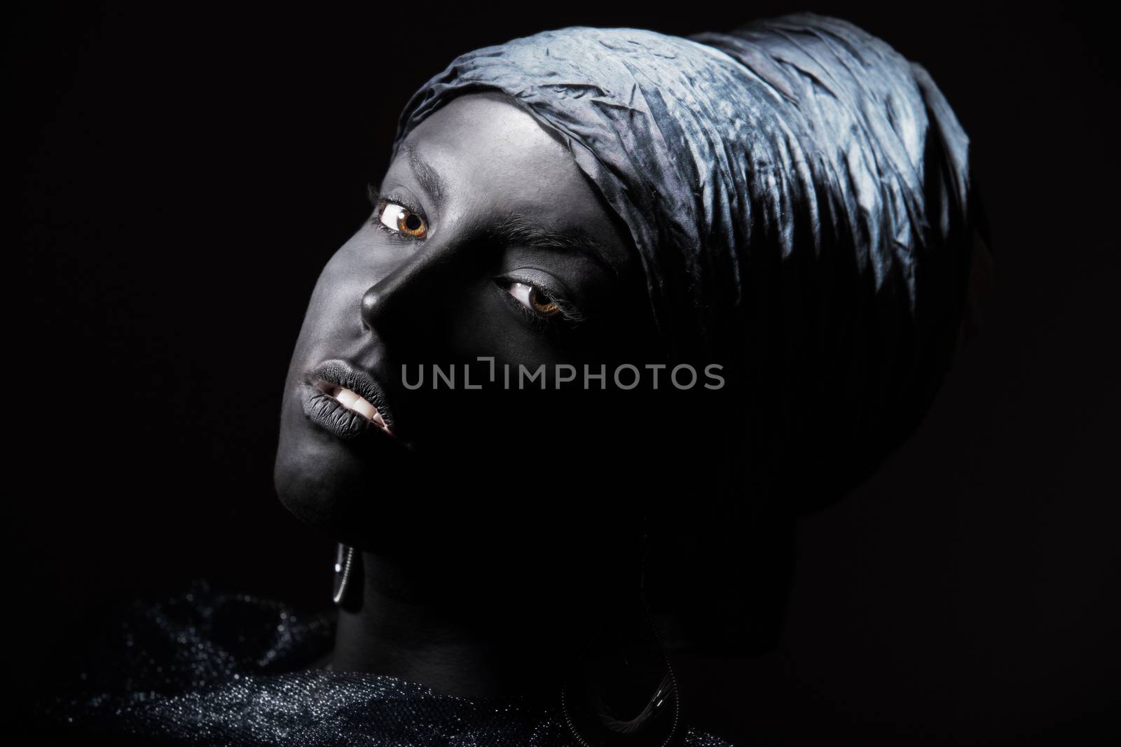 Woman with black skin in African turban. Studio shot