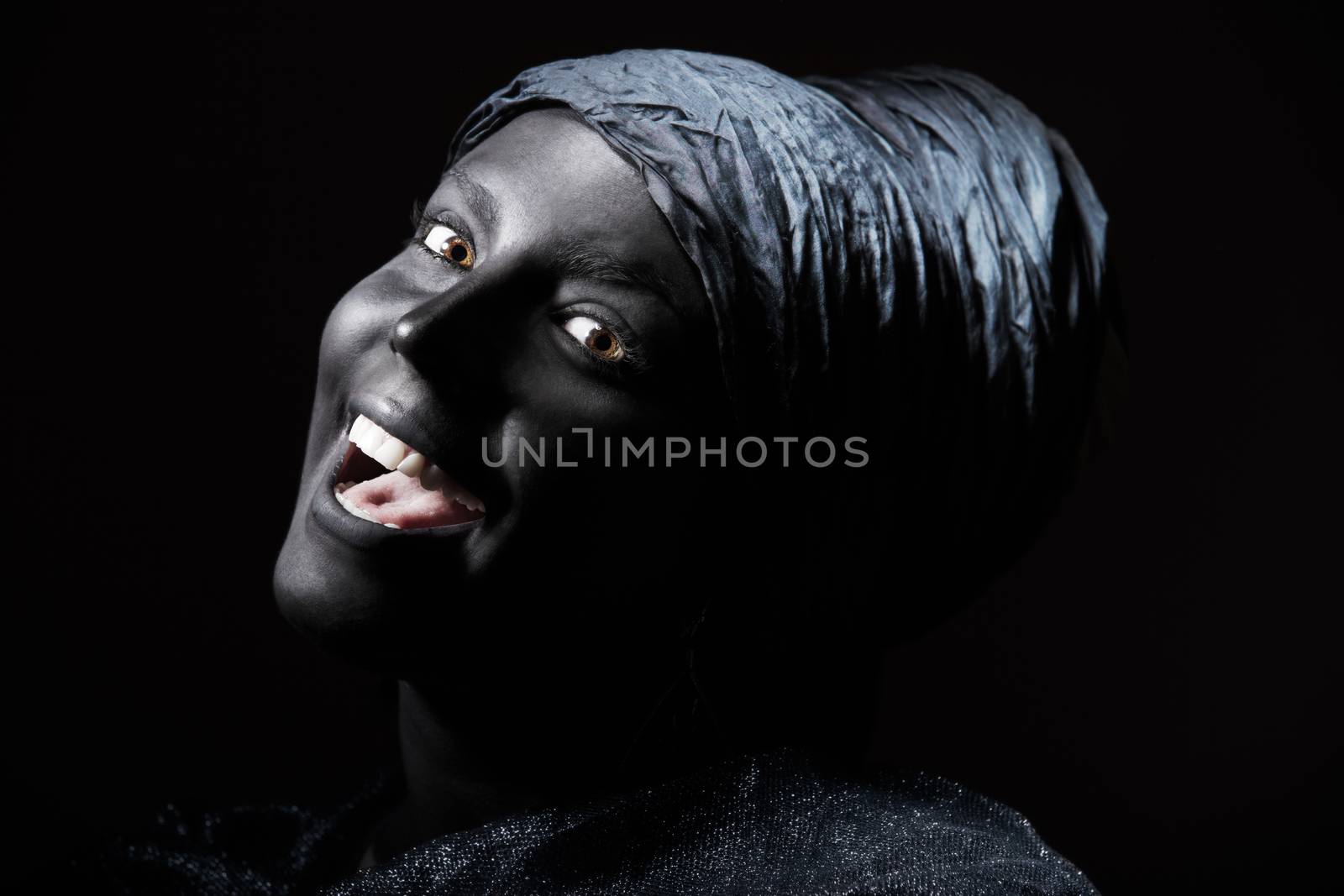 Woman with black skin in African turban. Studio shot