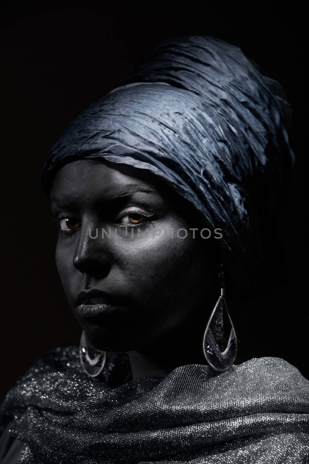 Woman with black skin in traditional turban. Studio shot