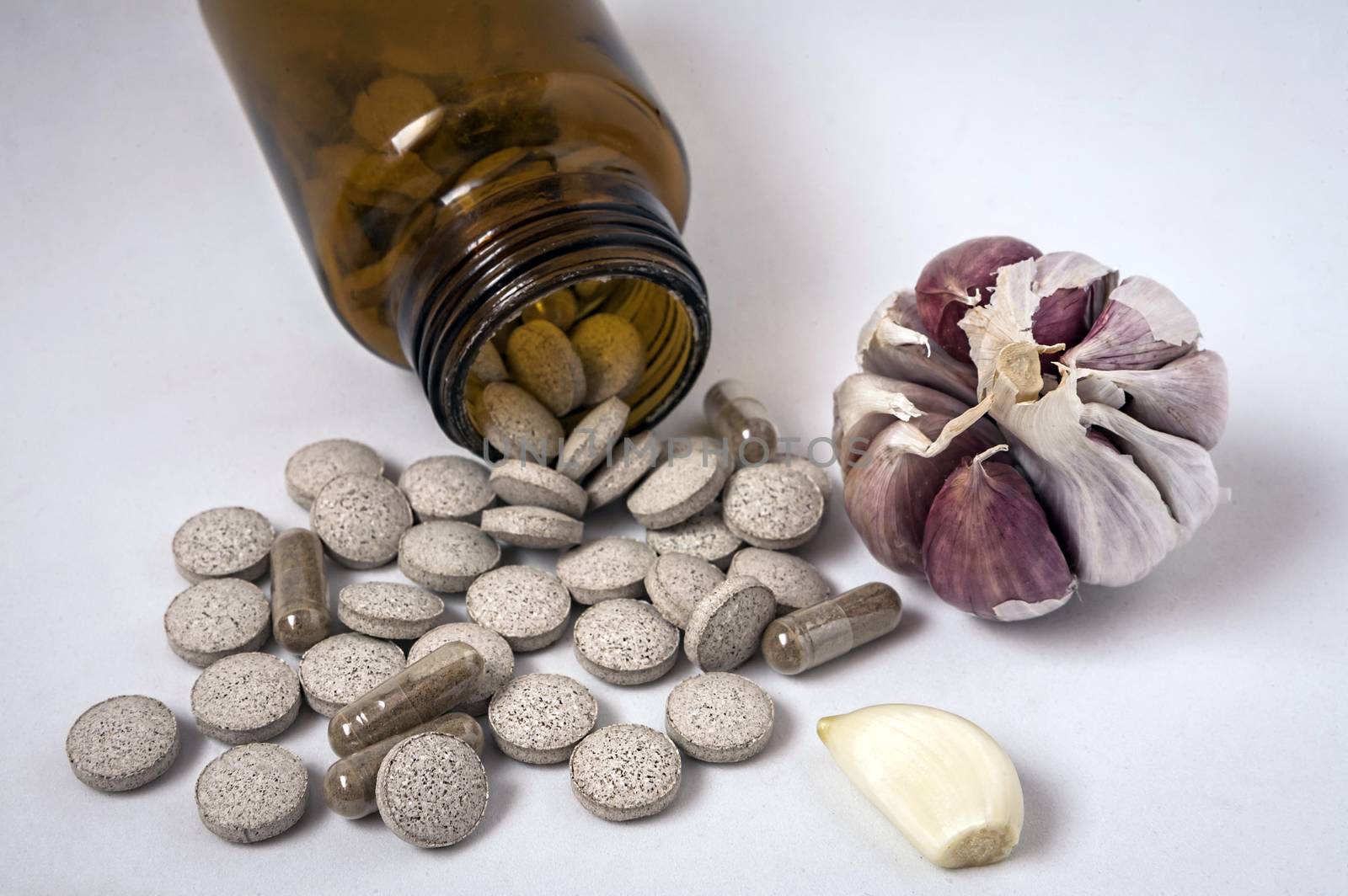 Garlic capsules, vitamins d pills  by digicomphoto