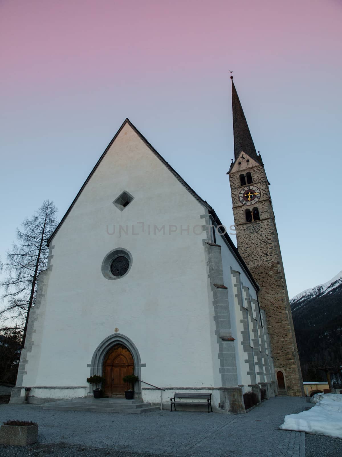 Scuol church in winter time evening by pyty