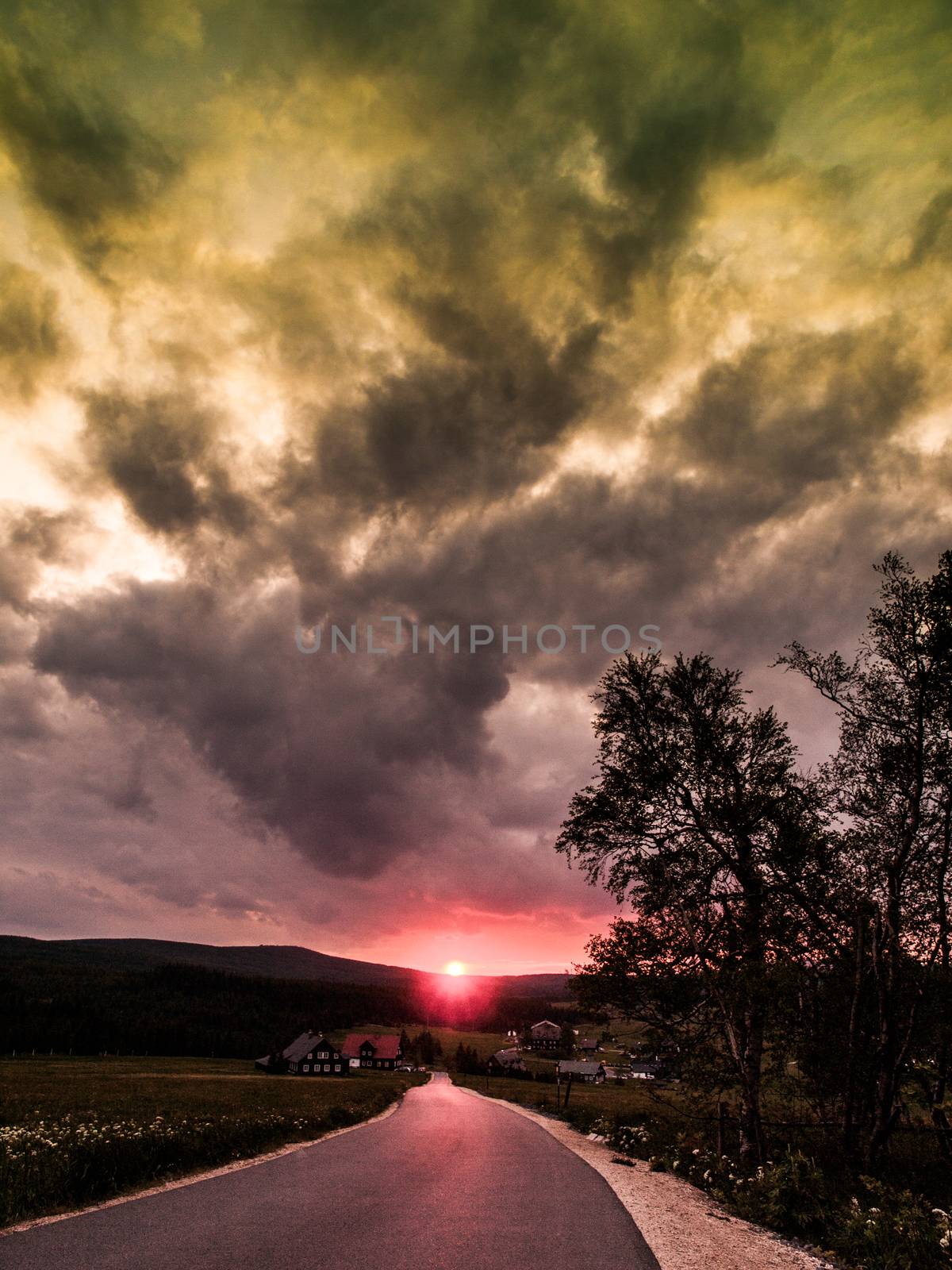 On the road at sunset time near Jizerka village (Czech Republic)