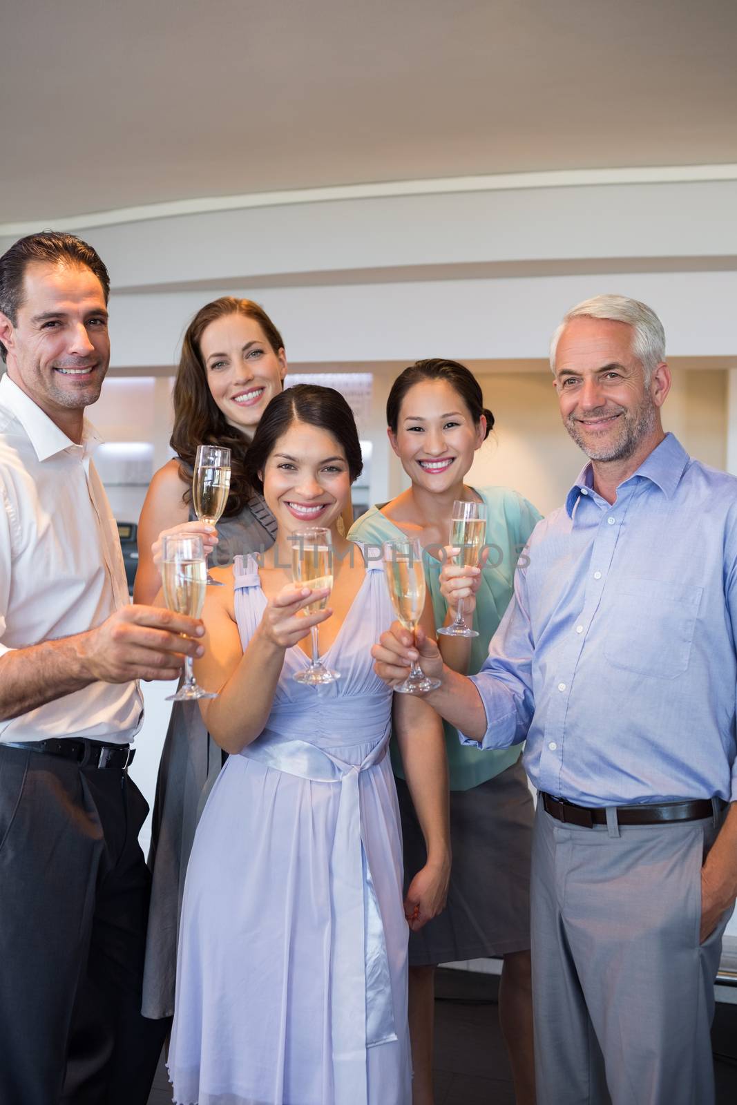 Portrait of happy people holding champagne flutes