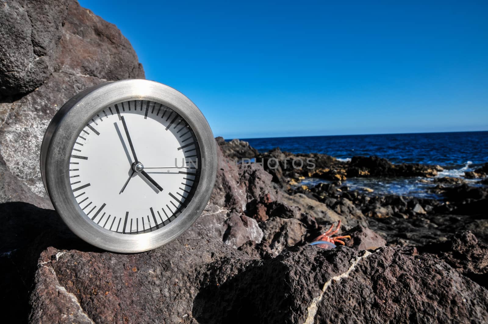 Time Concept Alarm Clock on the Volcanic Rocks