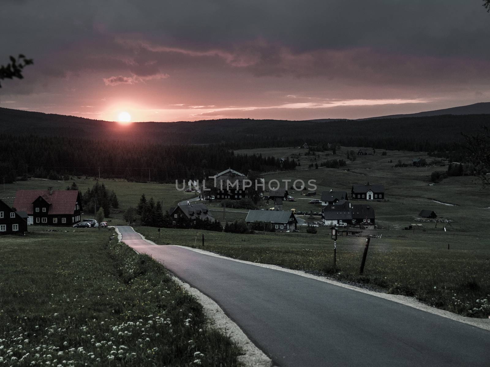 On the road at sunset time near Jizerka village (Czech Republic)