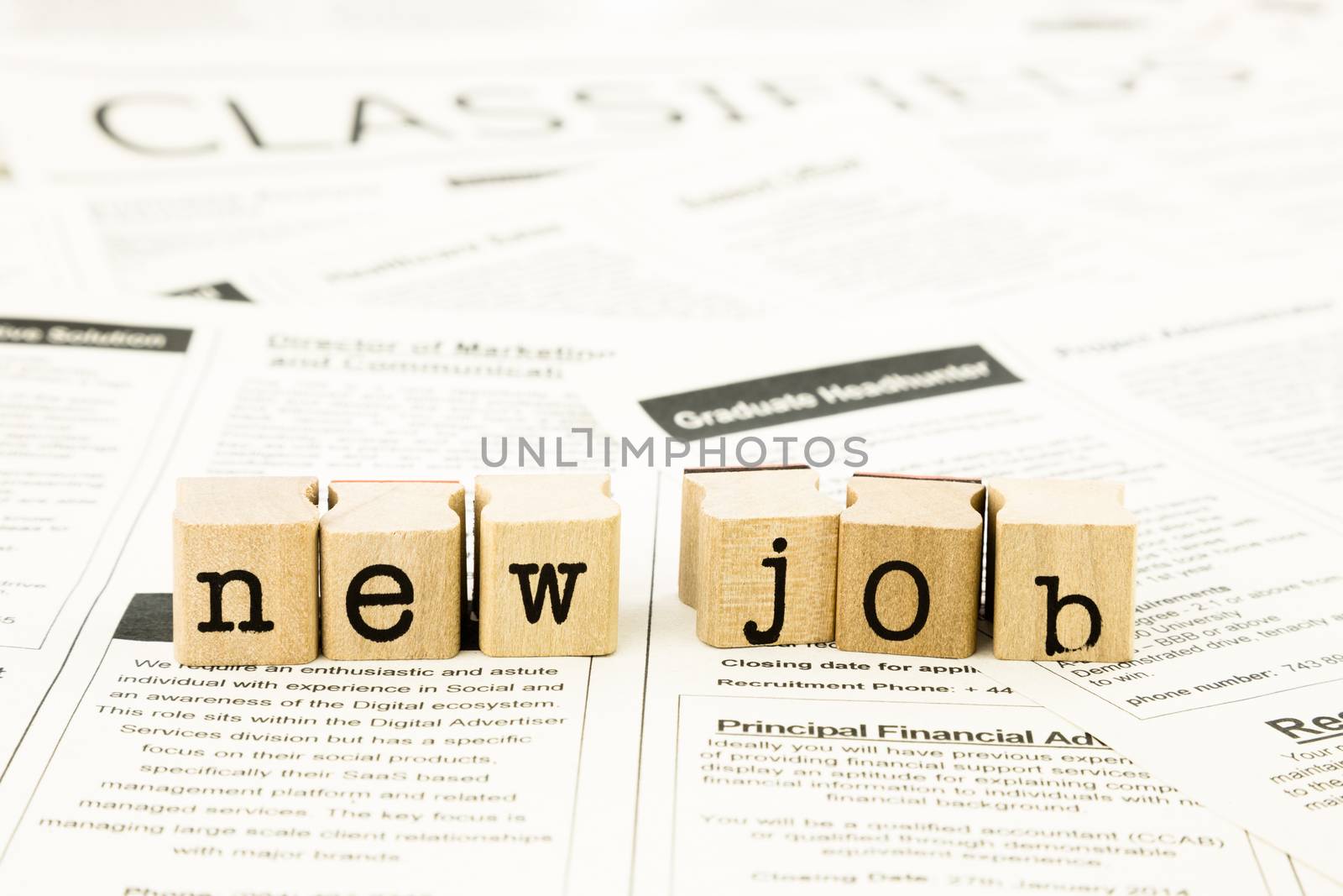closeup new job wording on classifieds ads and newspaper, recruitment and employment concepts and ideas