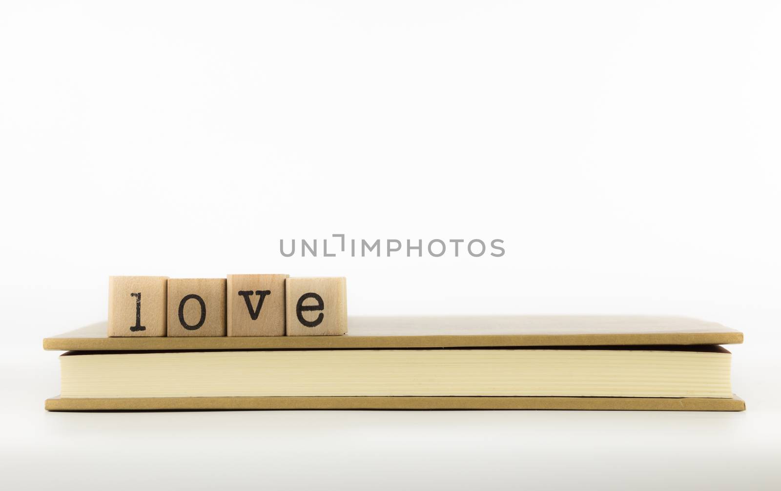 closeup love wording stack on a book, emotion concept and idea