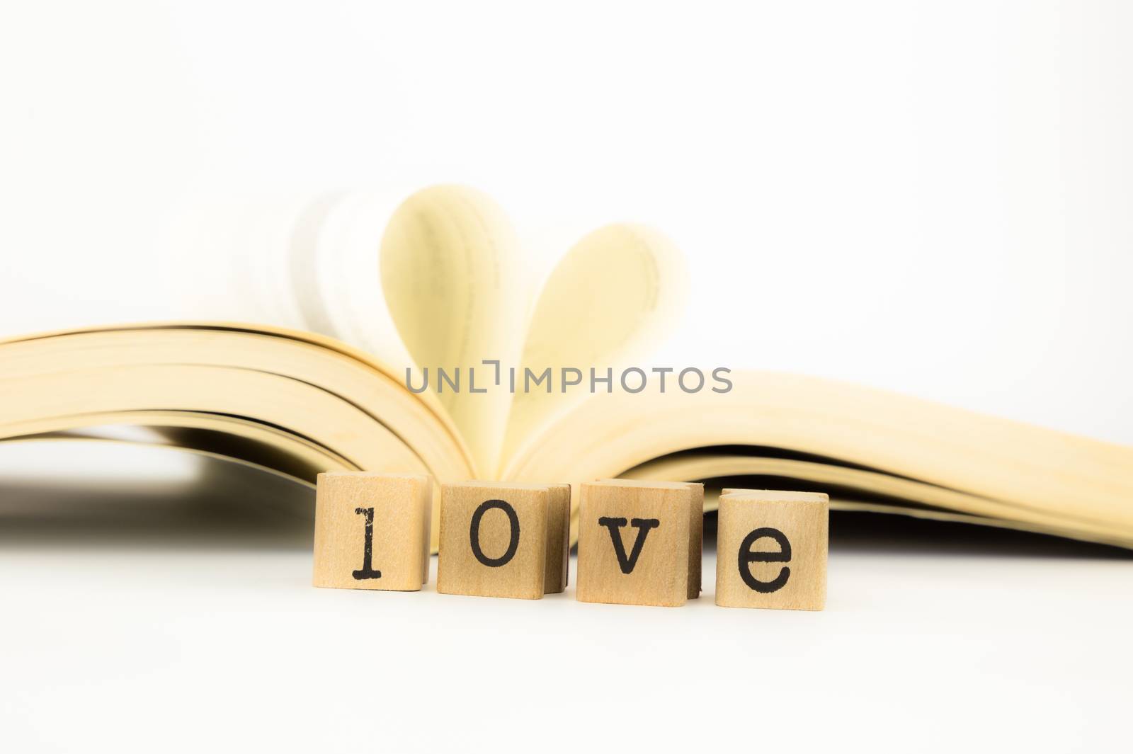 love wording and a book with heart shape by vinnstock