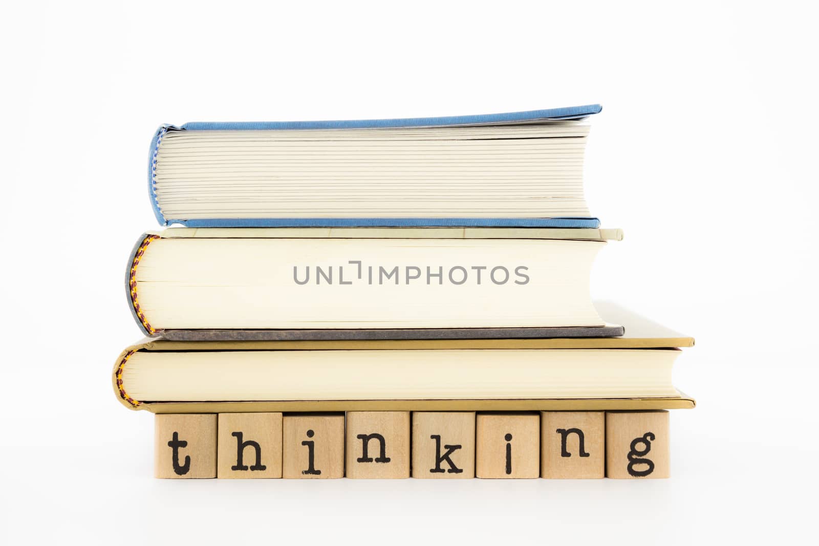 closeup thinking wording and books isolate on white background, concept and idea for business