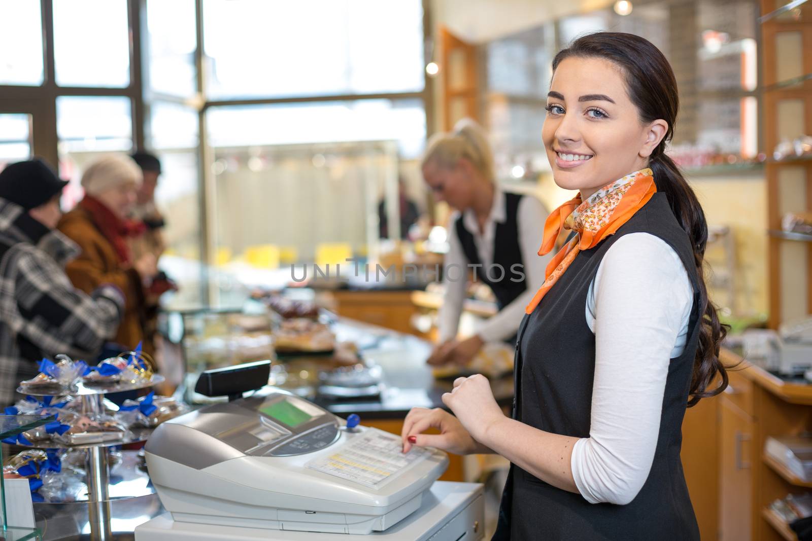 Shopkeeper and saleswoman at cash register or checkout counter