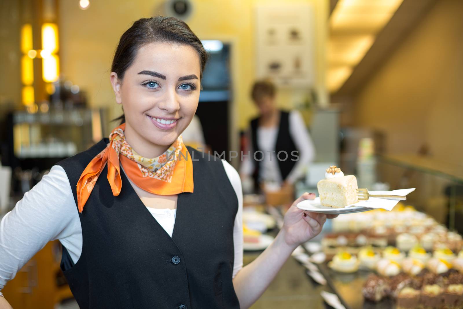 waitress or server presenting cake in cafe