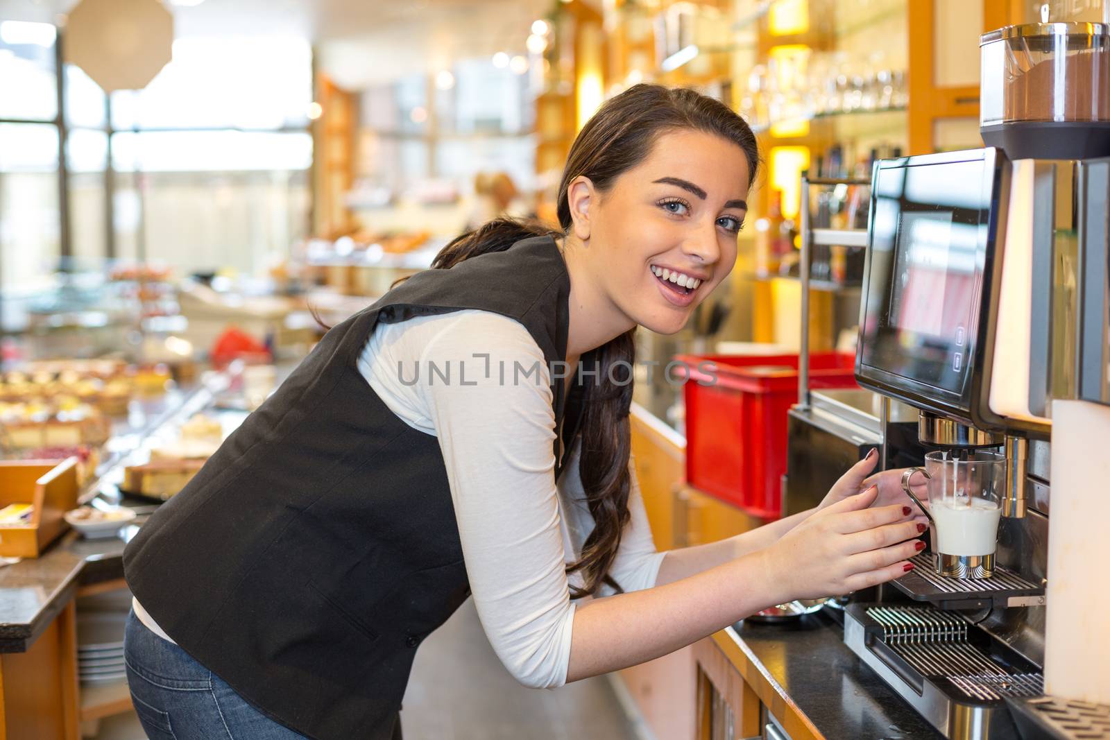 Waitress in cafe or restaurant and coffee machine by ikonoklast_fotografie