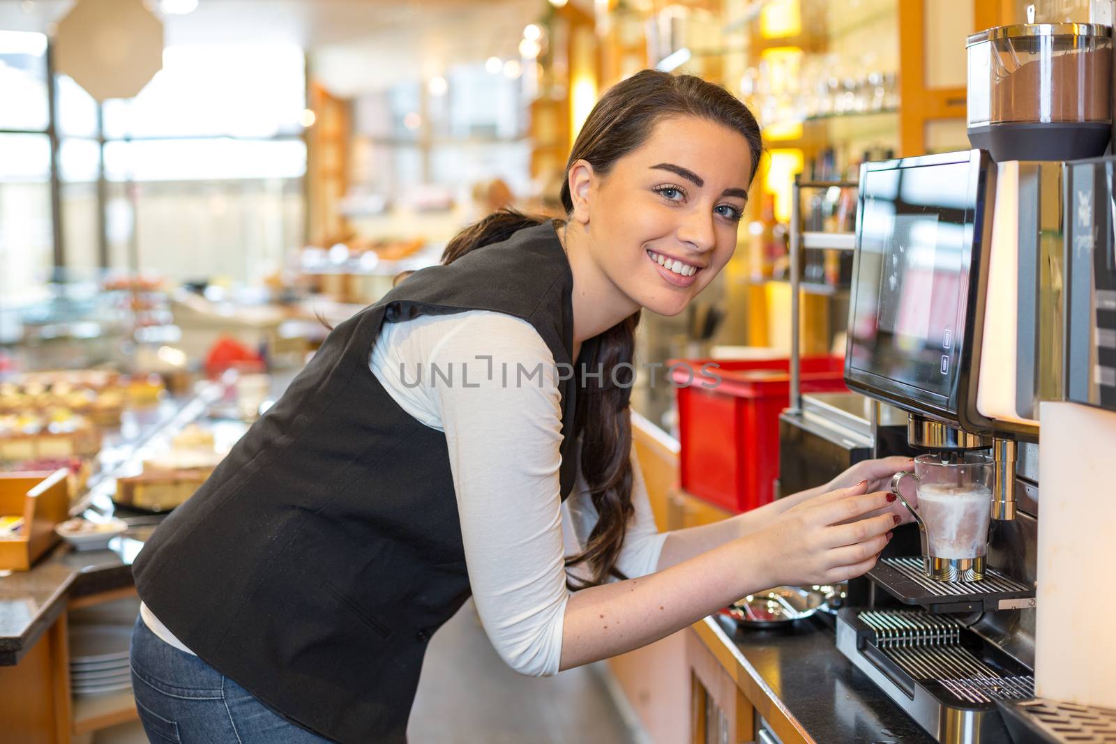 Waitress in cafe or restaurant and coffee machine by ikonoklast_fotografie