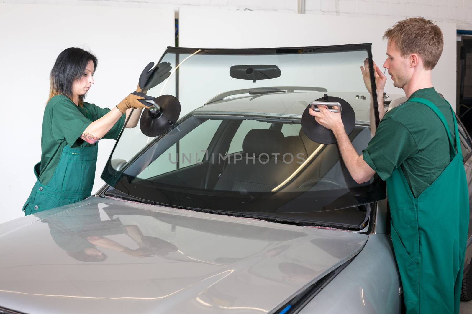 Glazier replacing windshield by ikonoklast_fotografie