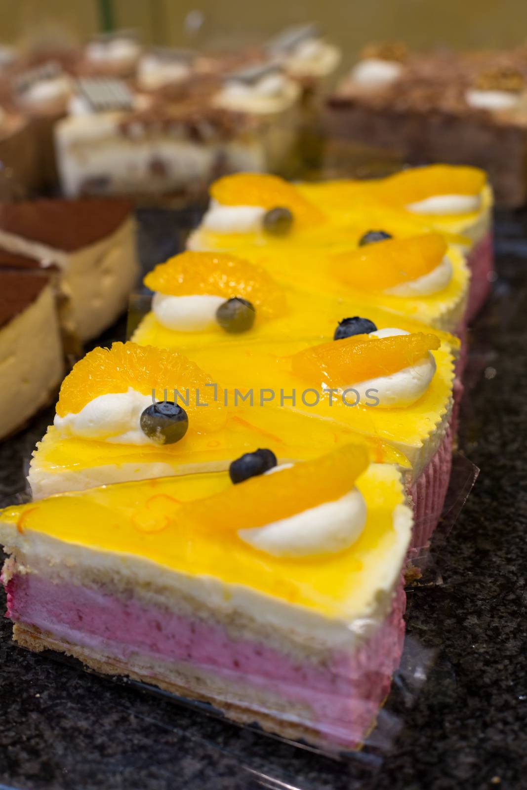 Cake displayed in confectionery or cafe by ikonoklast_fotografie