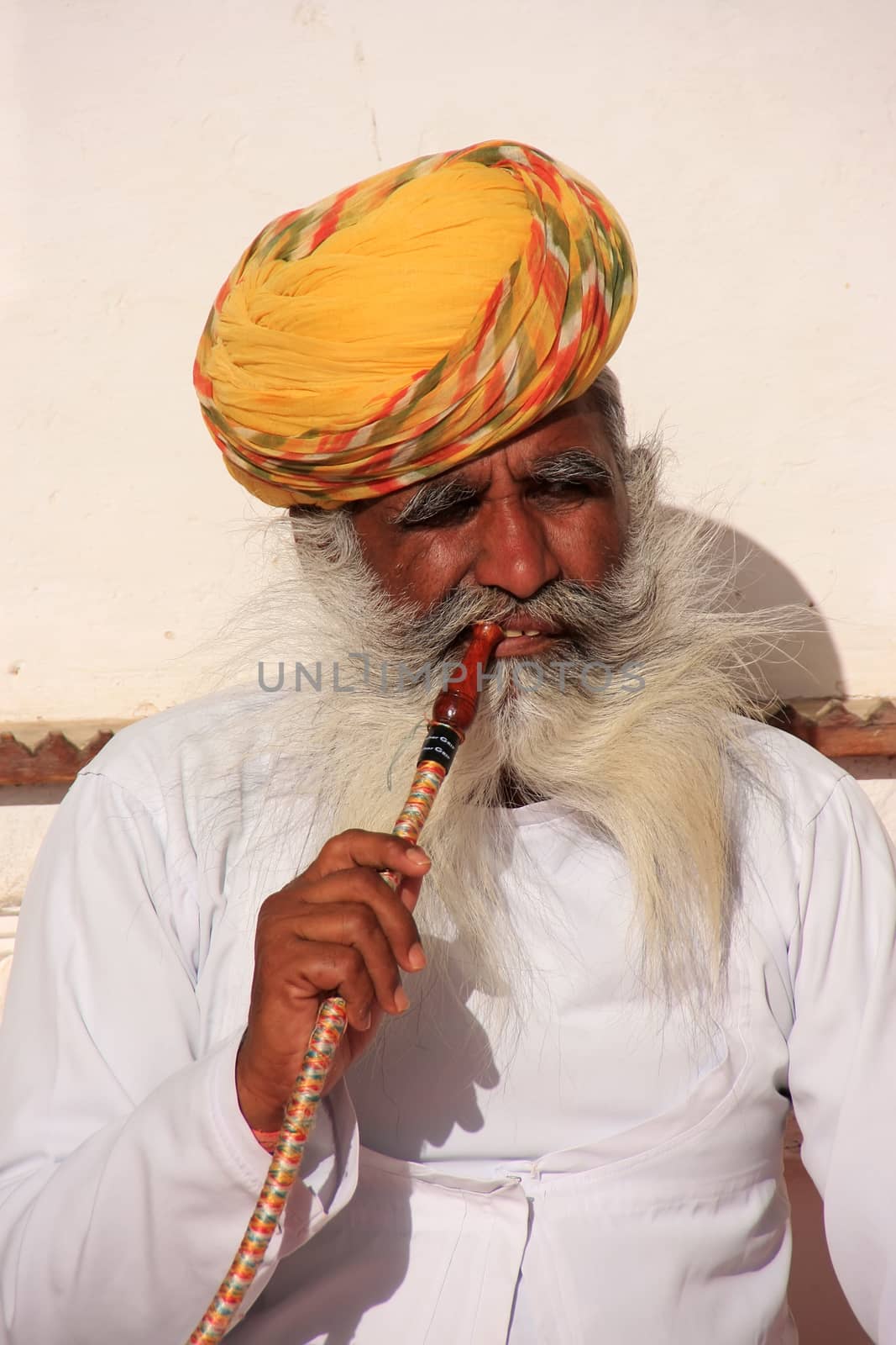 Indian man sitting at Mehrangarh Fort, Jodhpur, India by donya_nedomam