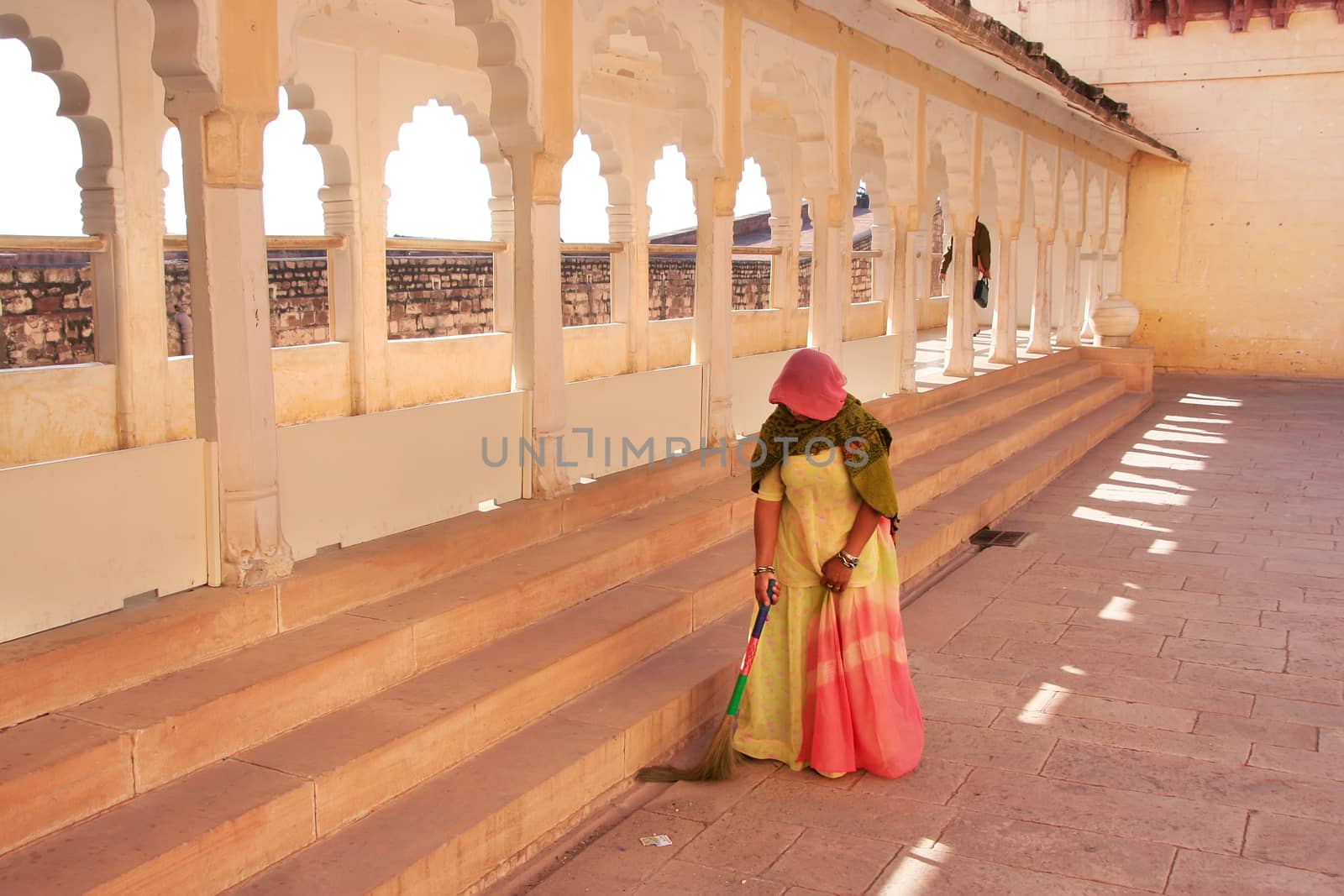 Indian woman sweeping floor, Mehrangarh Fort, Jodhpur, India by donya_nedomam