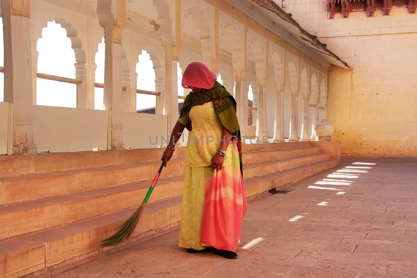 Indian woman sweeping floor, Mehrangarh Fort, Jodhpur, India by donya_nedomam