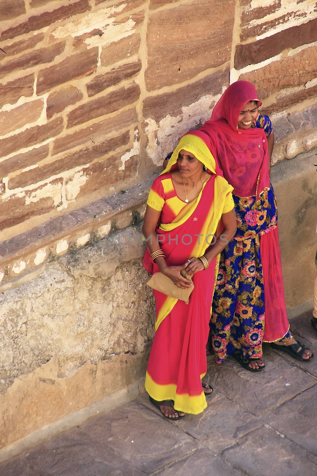 Indian women standing by the wall, Mehrangarh Fort, Jodhpur, Ind by donya_nedomam