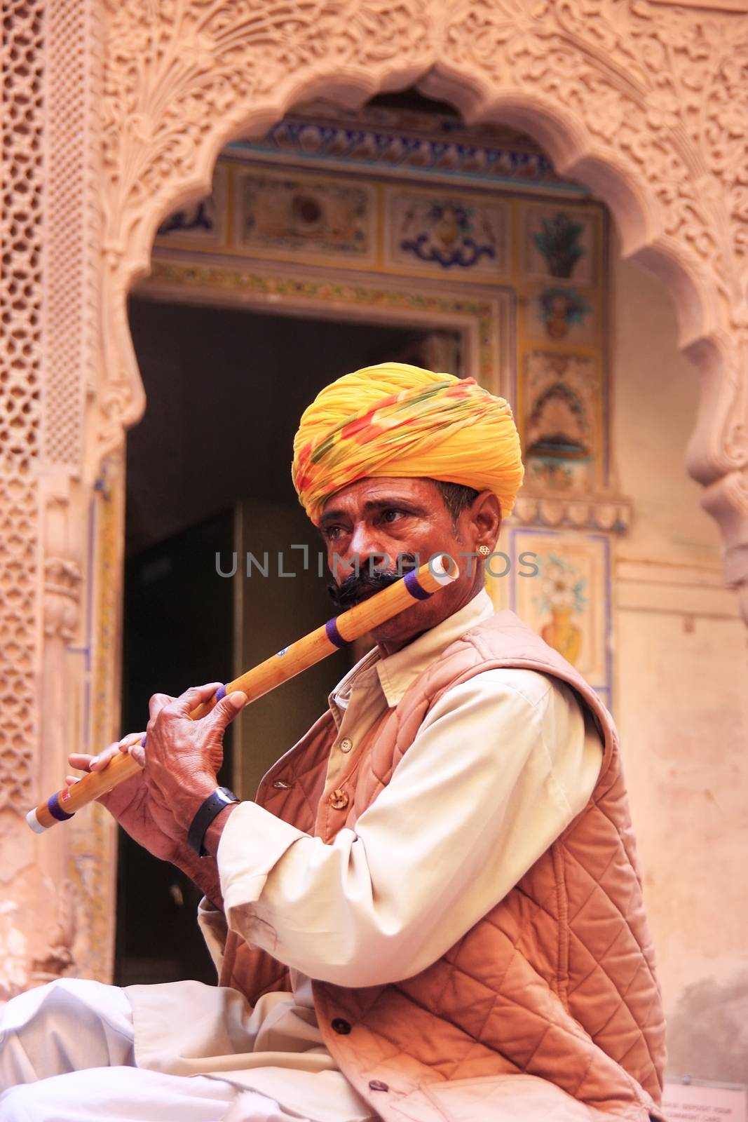 Indian man playing flute, Mehrangarh Fort, Jodhpur, Rajasthan, India