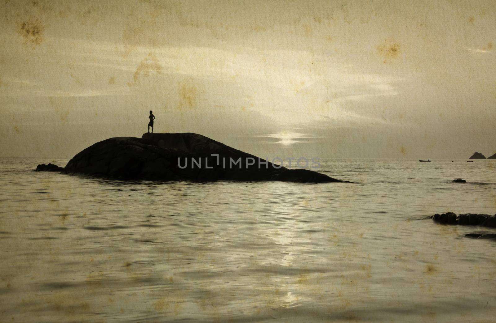 Lonely Man standing on small stone during sunset, grunge style