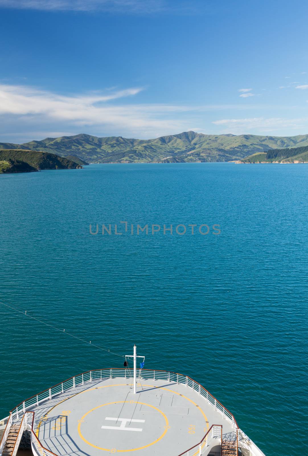 Cruise ship bow approaching the coastline around Akaroa harbour near Christchurch on South Island of New Zealand