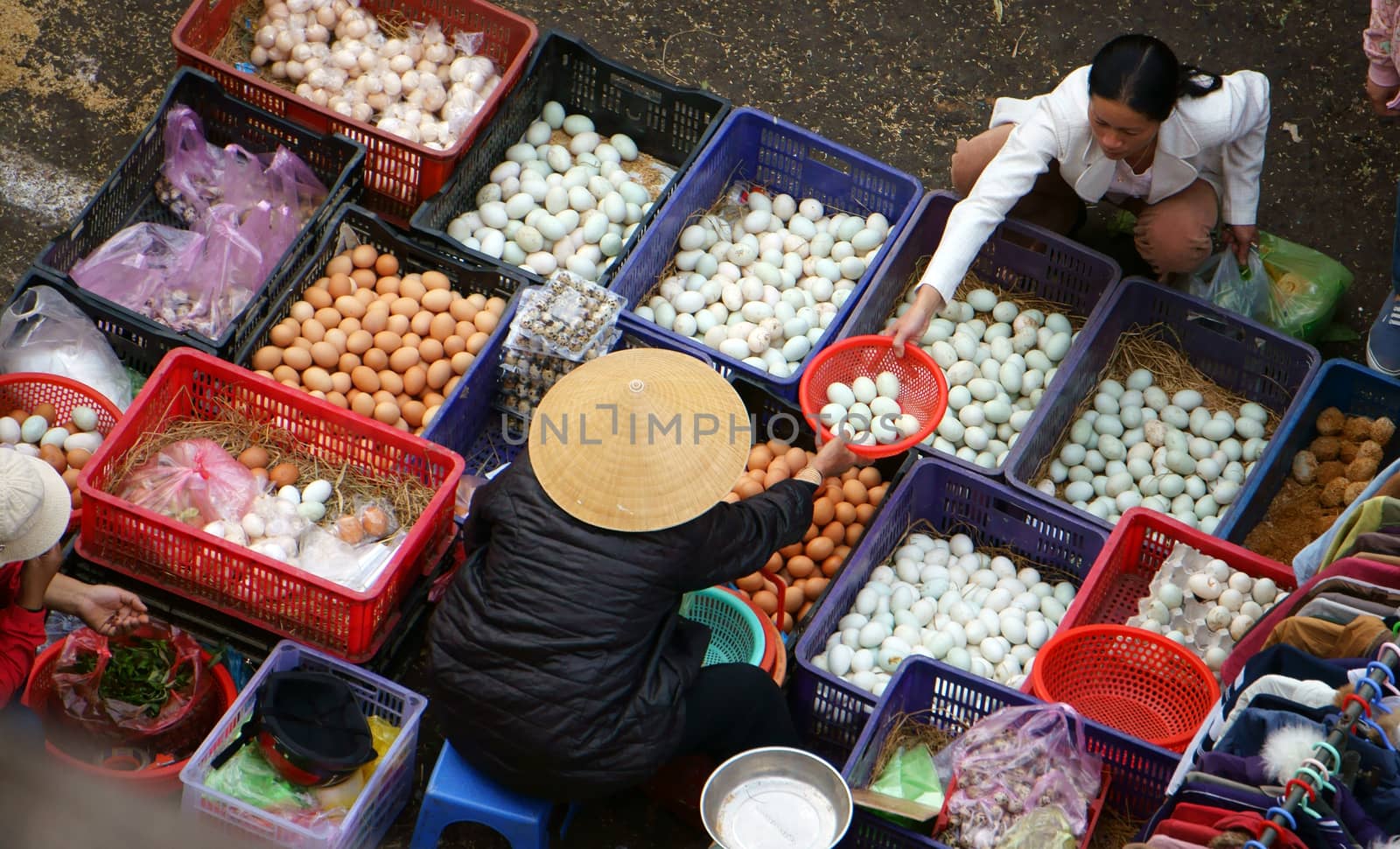 DA LAT, VIET NAM- FEBRUARY 8.People sell and buy hen eggs, duck eggs at farmers market in  Dalat, VietNam- February 8, 2013