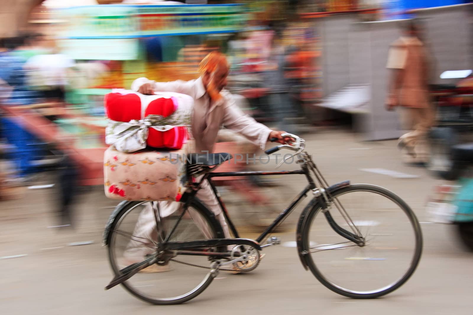 Indian man walking with his bike, blurred, motion, Sadar Market, Jodhpur, Rajasthan, India