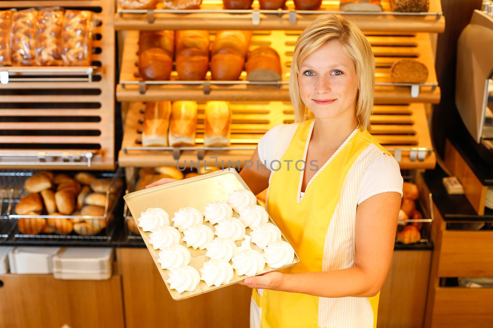 Bakery shopkeeper with tablet of meringue