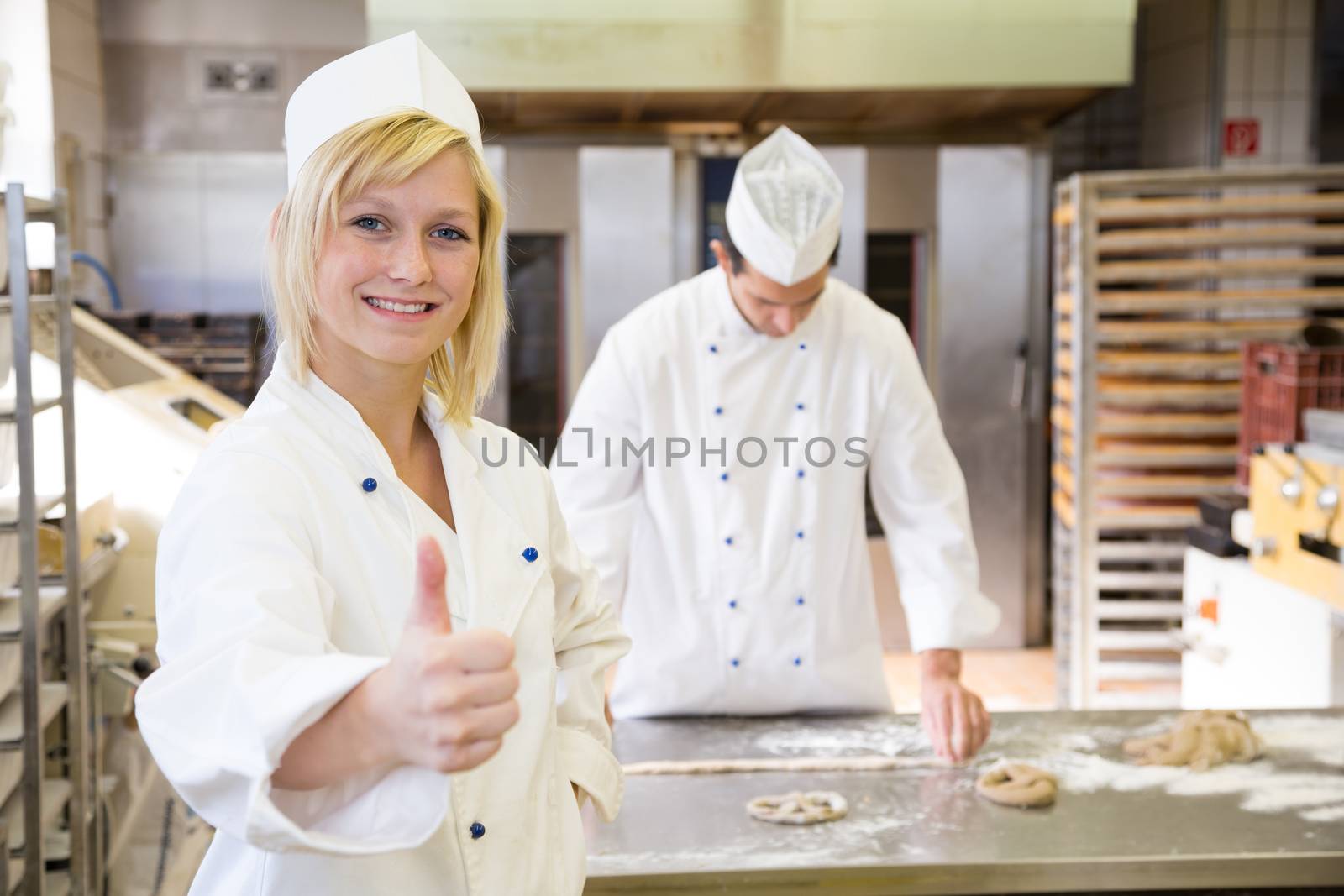 Baker posing in bakery or bakehouse by ikonoklast_fotografie