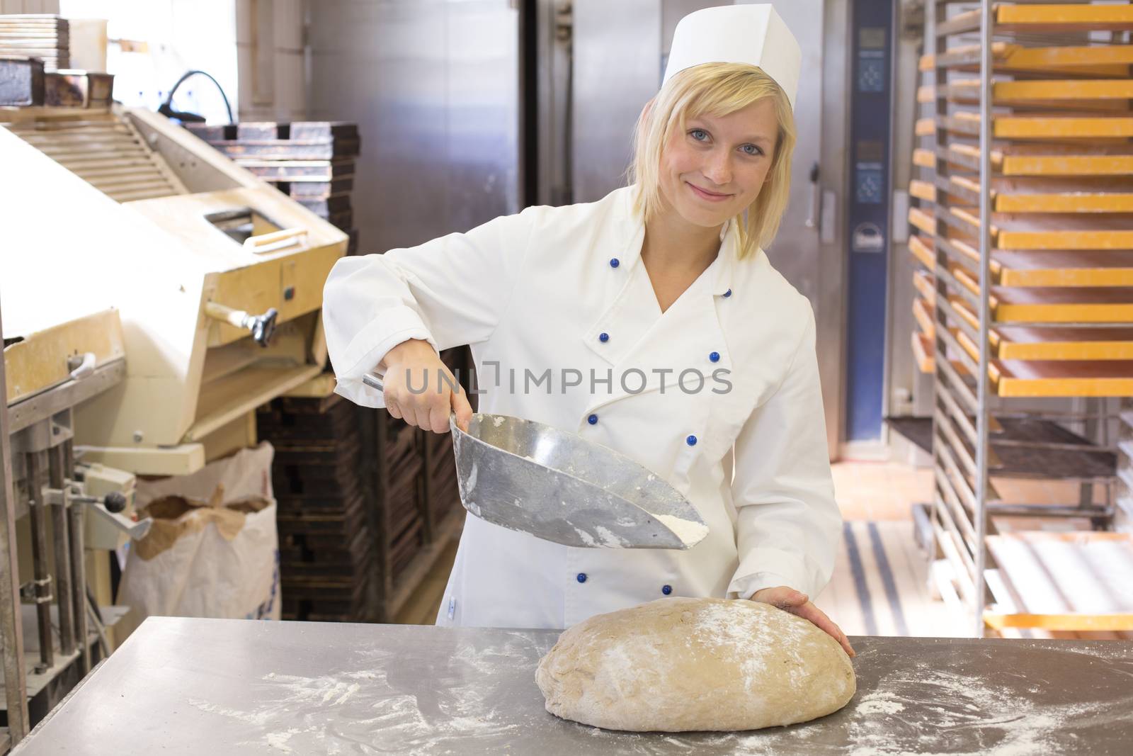 Baker preparing dough in a bakery or bakehouse