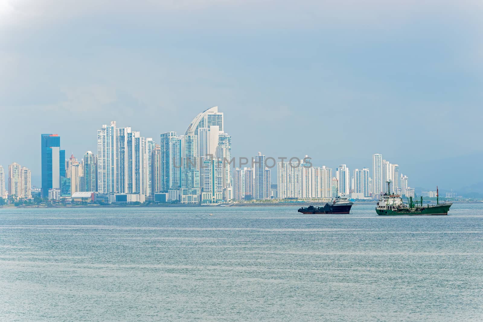 Shipping boats in Panama Bay on the background  Panama City skyscrapers skyline. Sunny day in January 2, 2014.