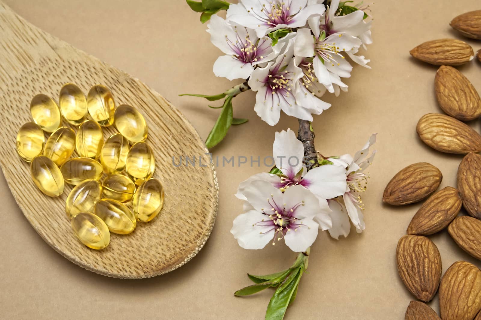 Almond oil in capsules isolated on brown background