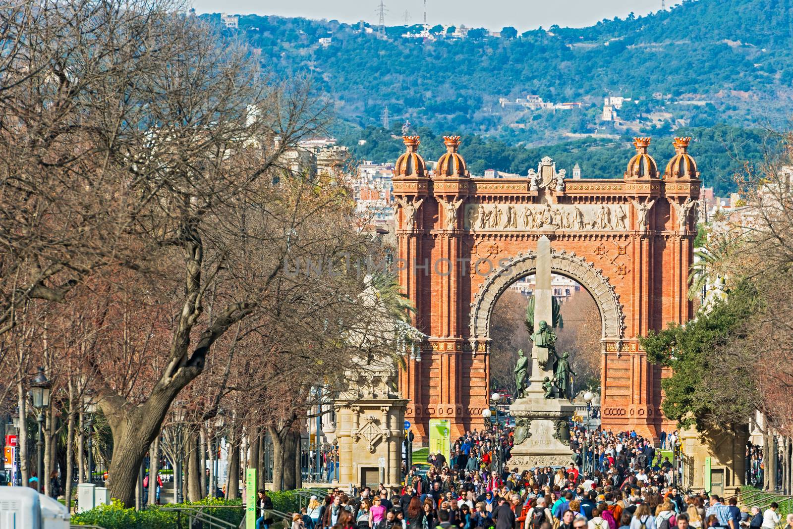 Barcelona, Spain - January 26, 2014: The Arc de Triumph in Barcelona, Spain was build in 1888 for Universal Exposition. The Arch served as  its archway to the exhibition. People walking by on a sunny day in January 26, 2014