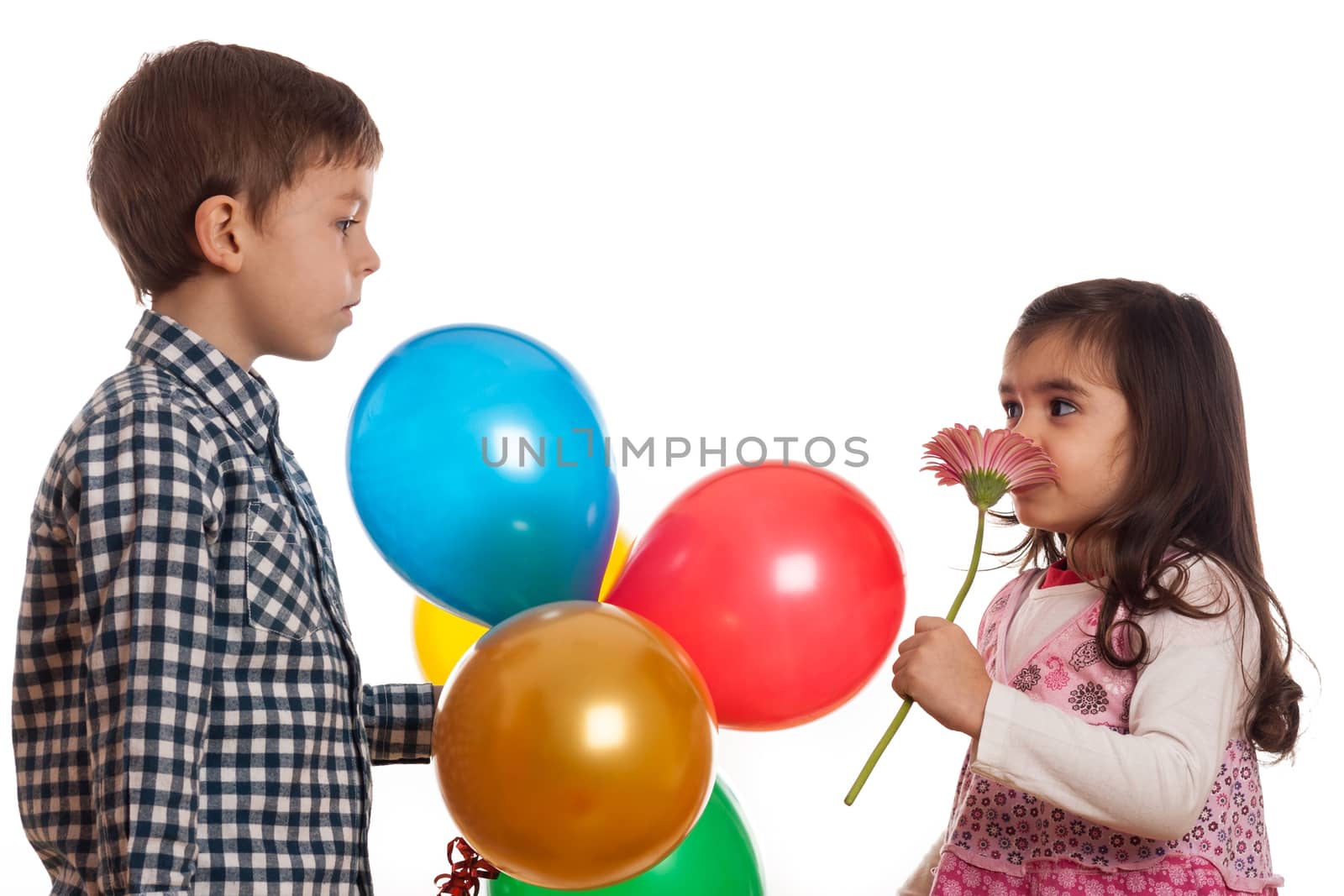 boy giving flower and balloons to girl on white background