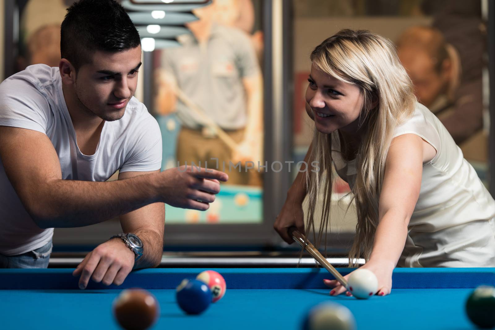 Man Showing His Girlfriend Where To Hit The Ball by JalePhoto