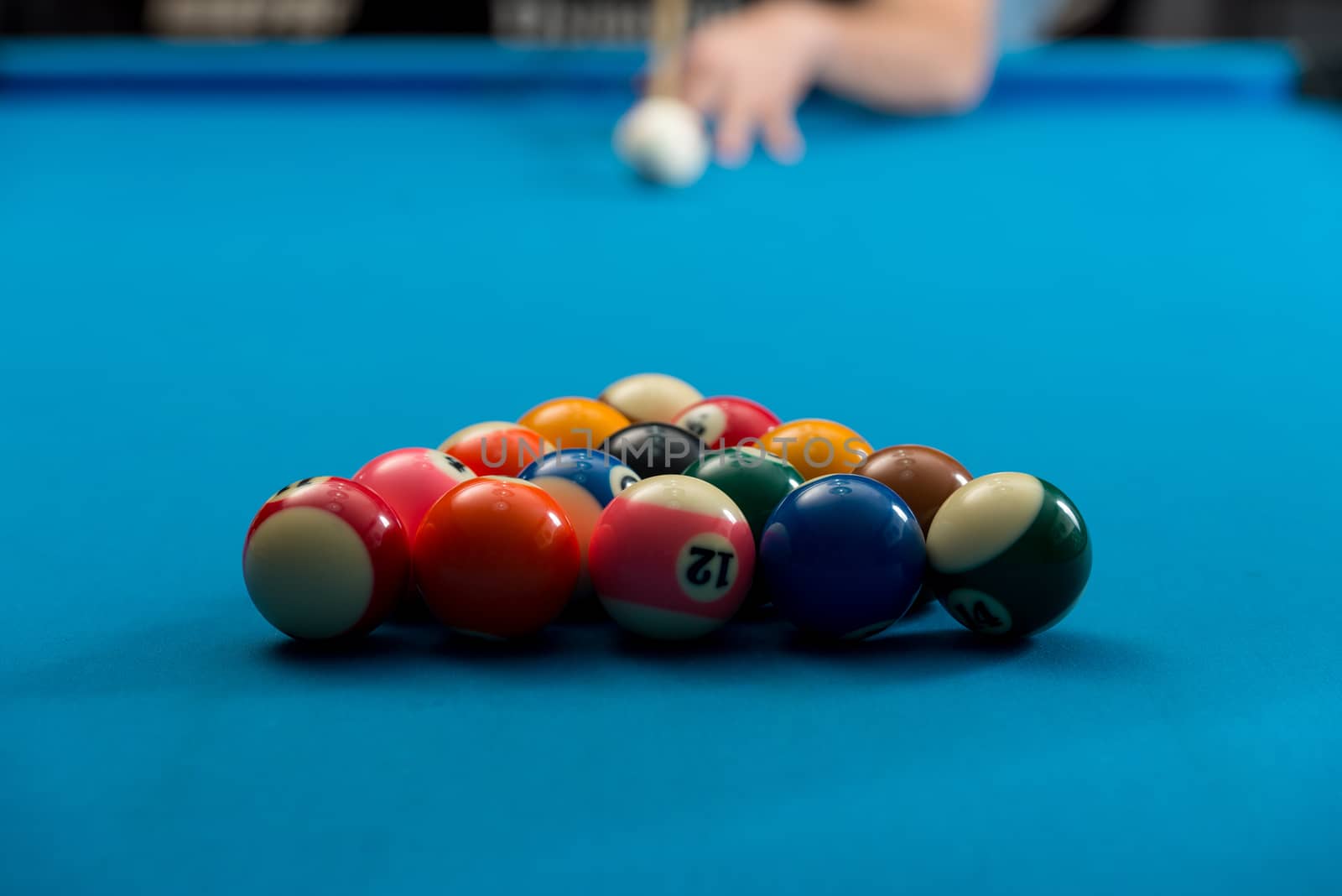 Man Playing Pool About to Hit Ball by JalePhoto
