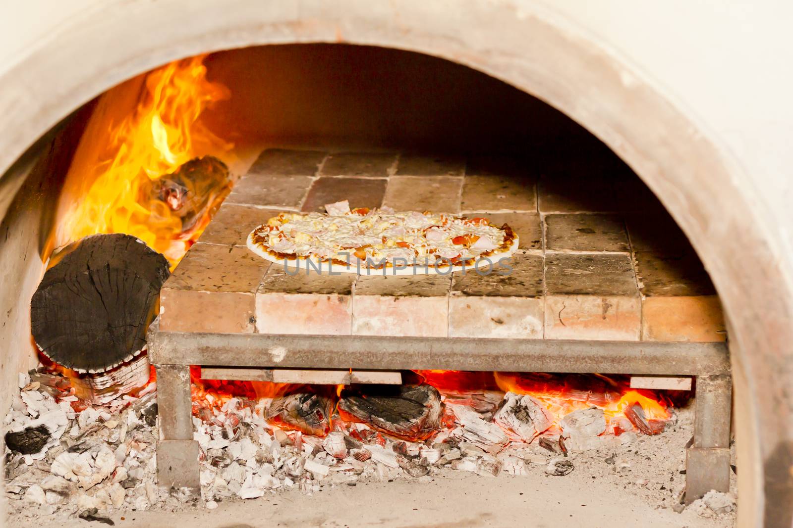 Pizza cooking in a tradition fire wood oven 