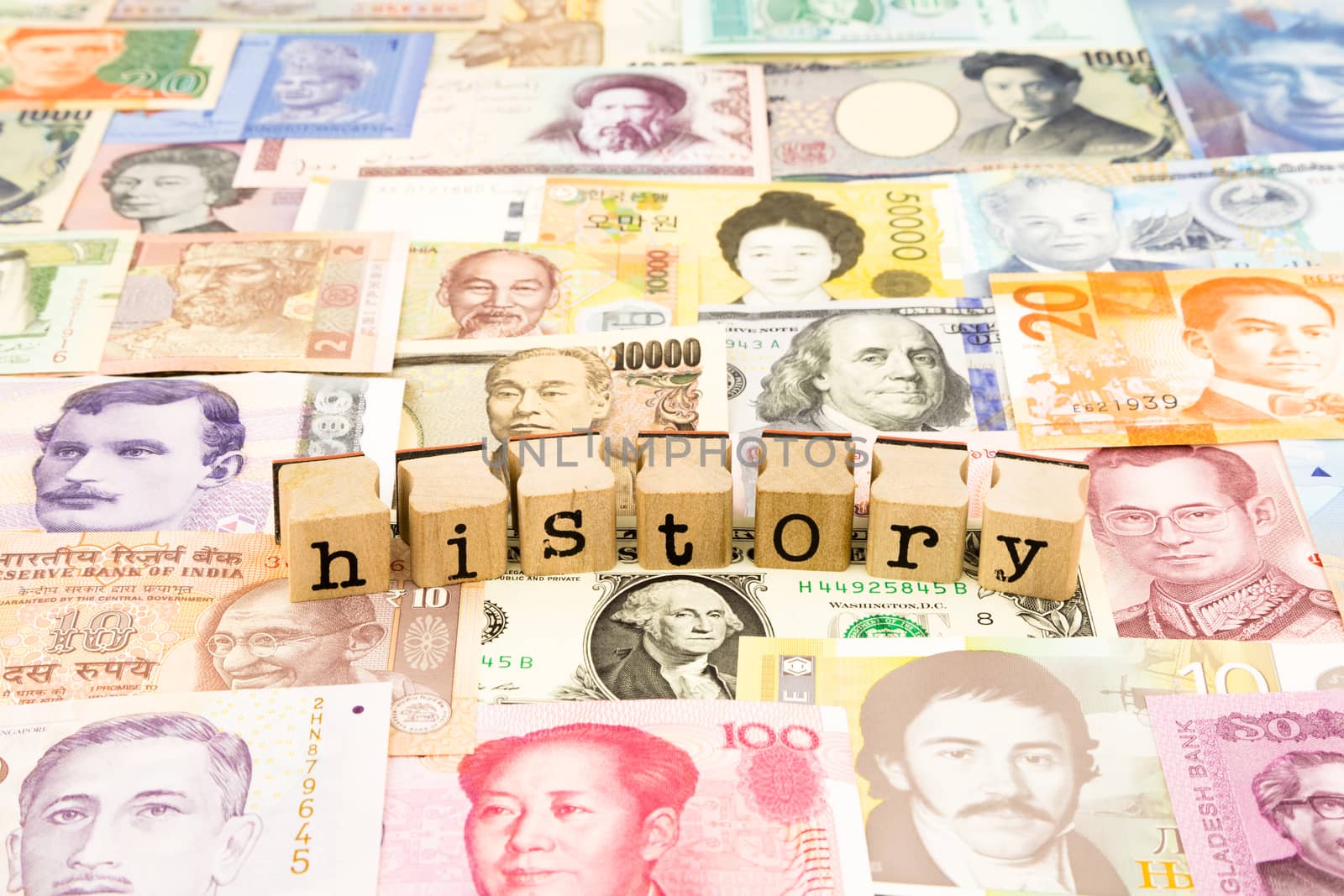 closeup history wording stack on banknotes, world currency, business and education concept and idea