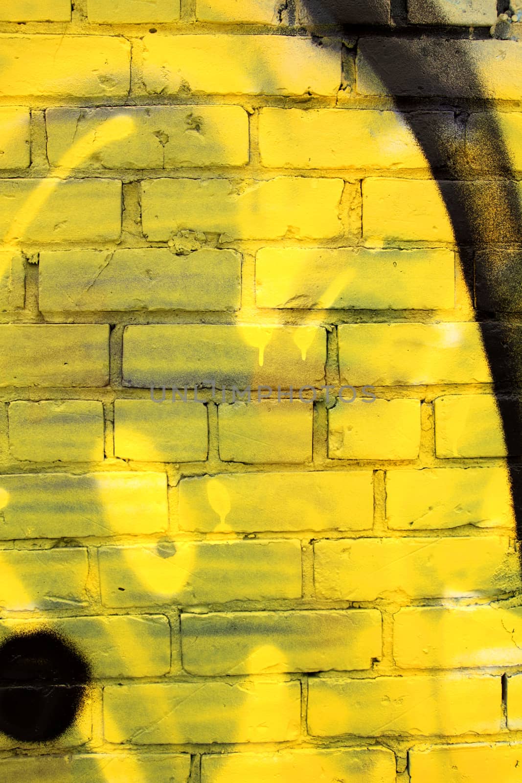 closeup of a painted yellow brick wall