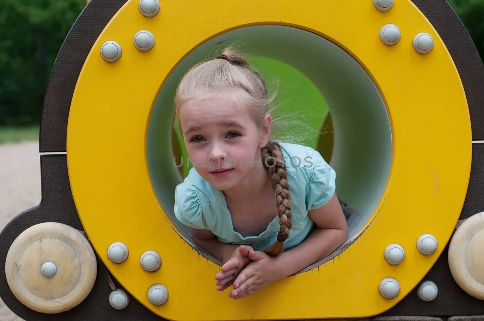 Young girl sitting in crawl tube by anytka
