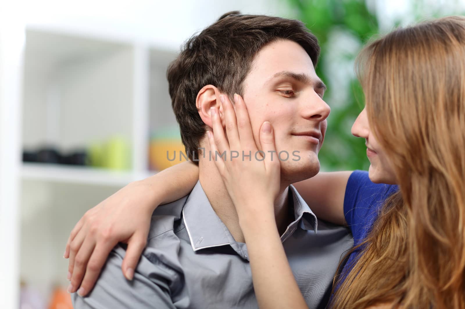 pretty woman stroking the cheek of her boyfriend with love