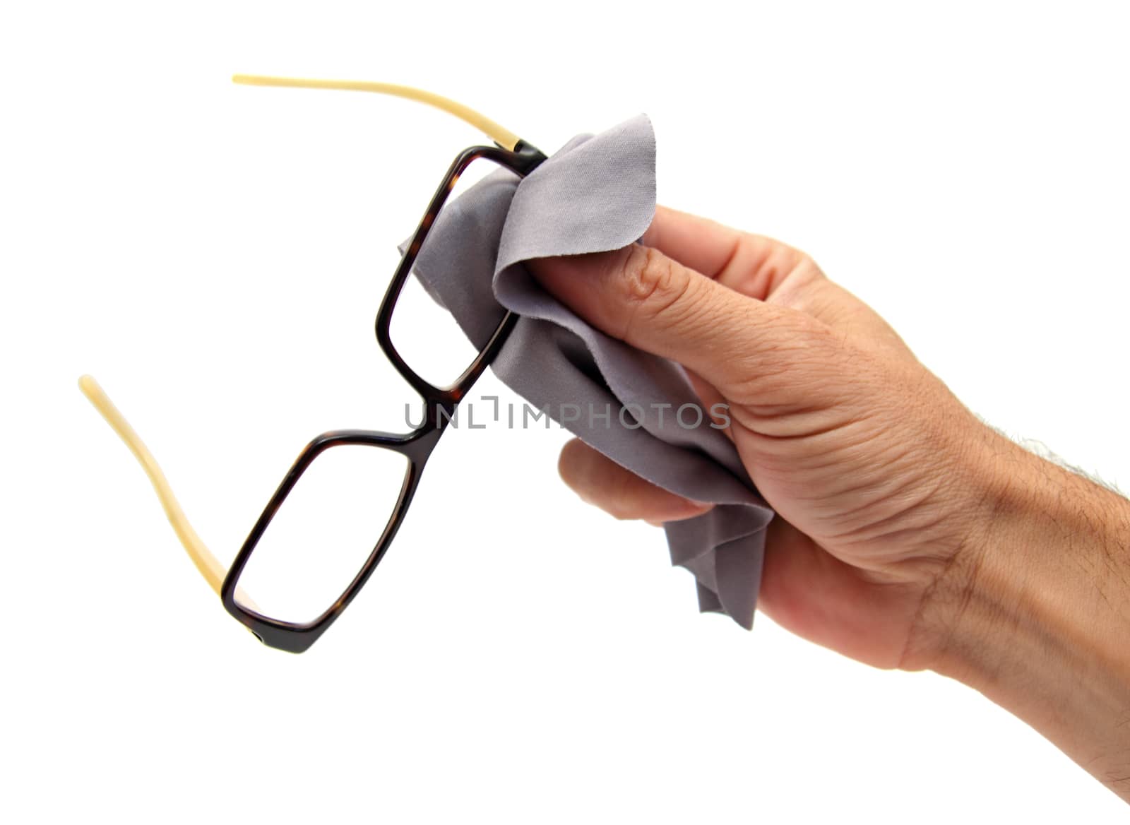 closeup of a hand cleaning glasses with a piece of tissue