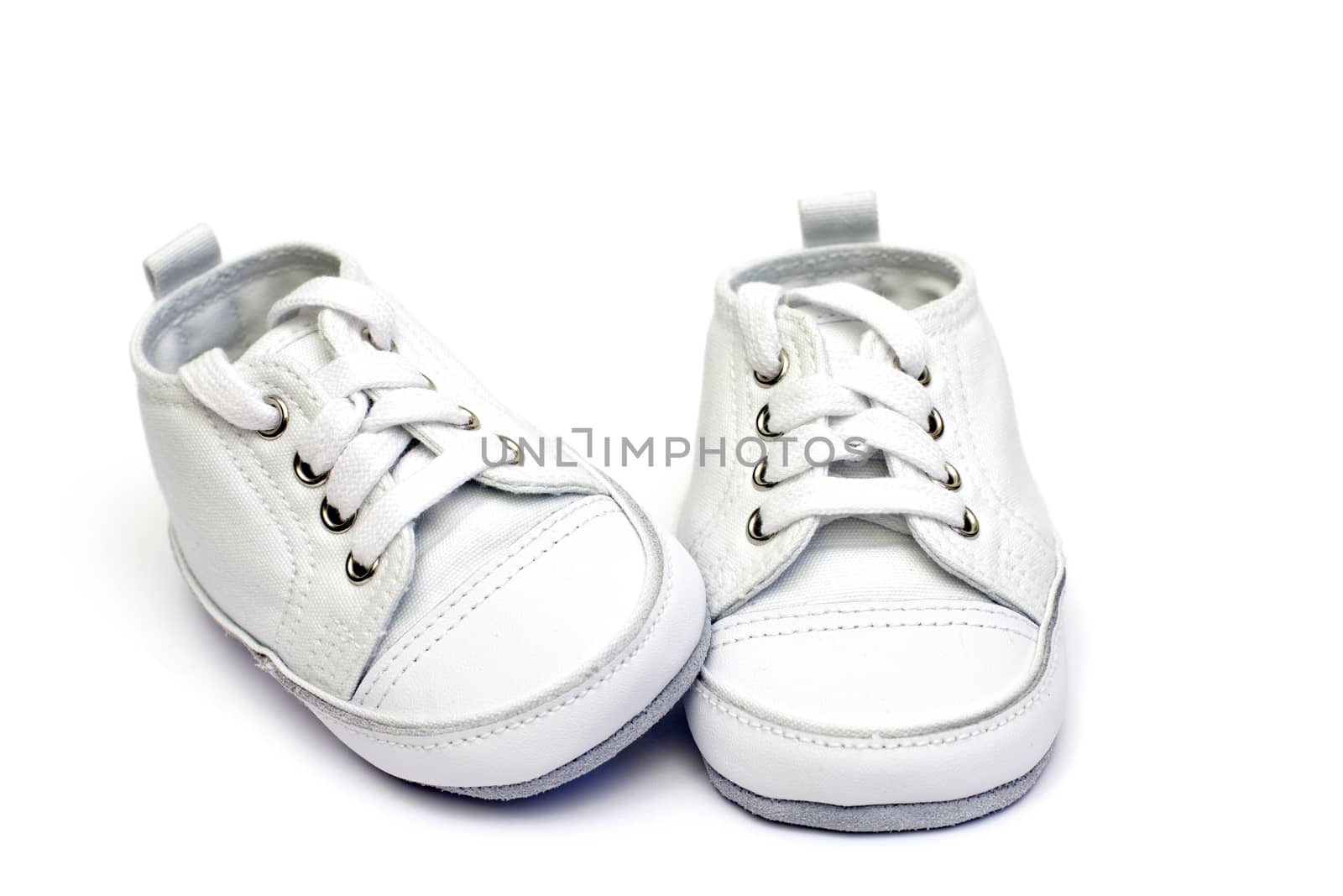 pair of white baby shoe over white