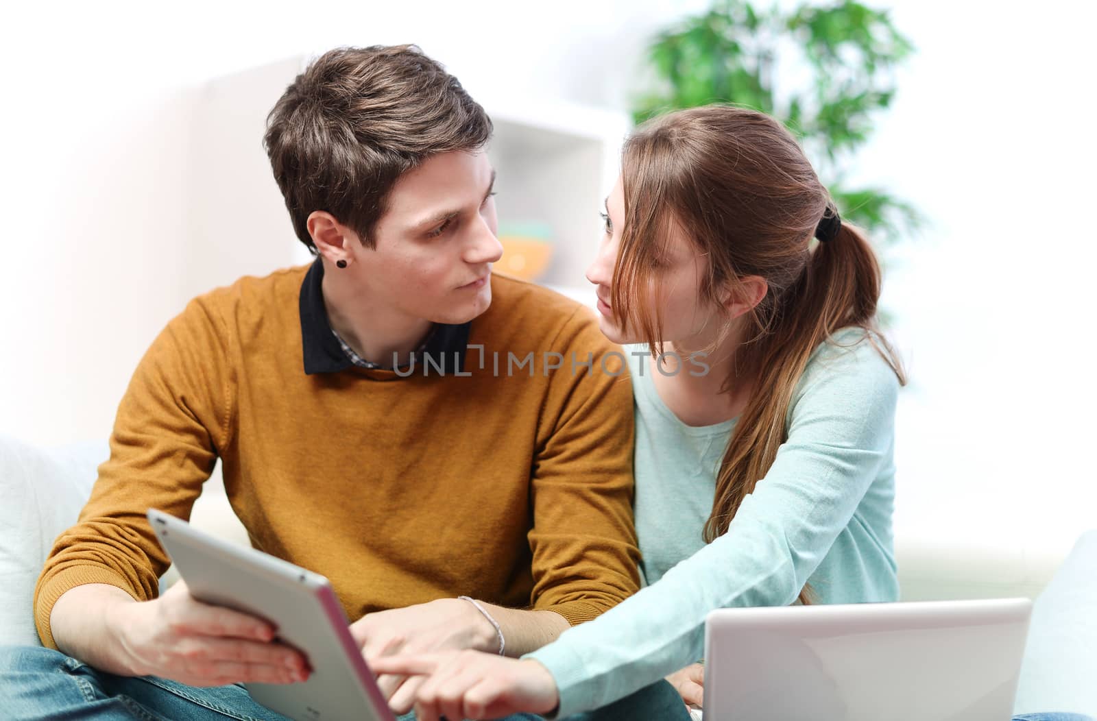 Attractive couple consulting something on a touchpad