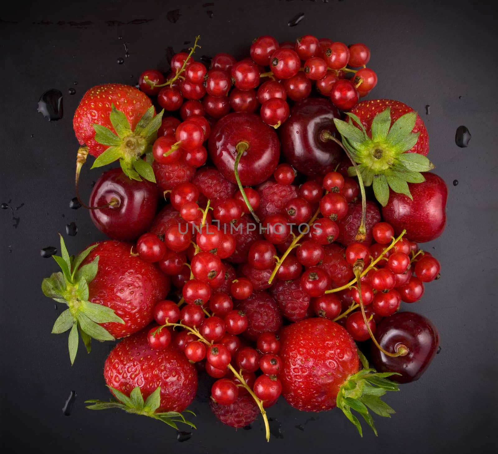 fresh red  fruit on black background by sette
