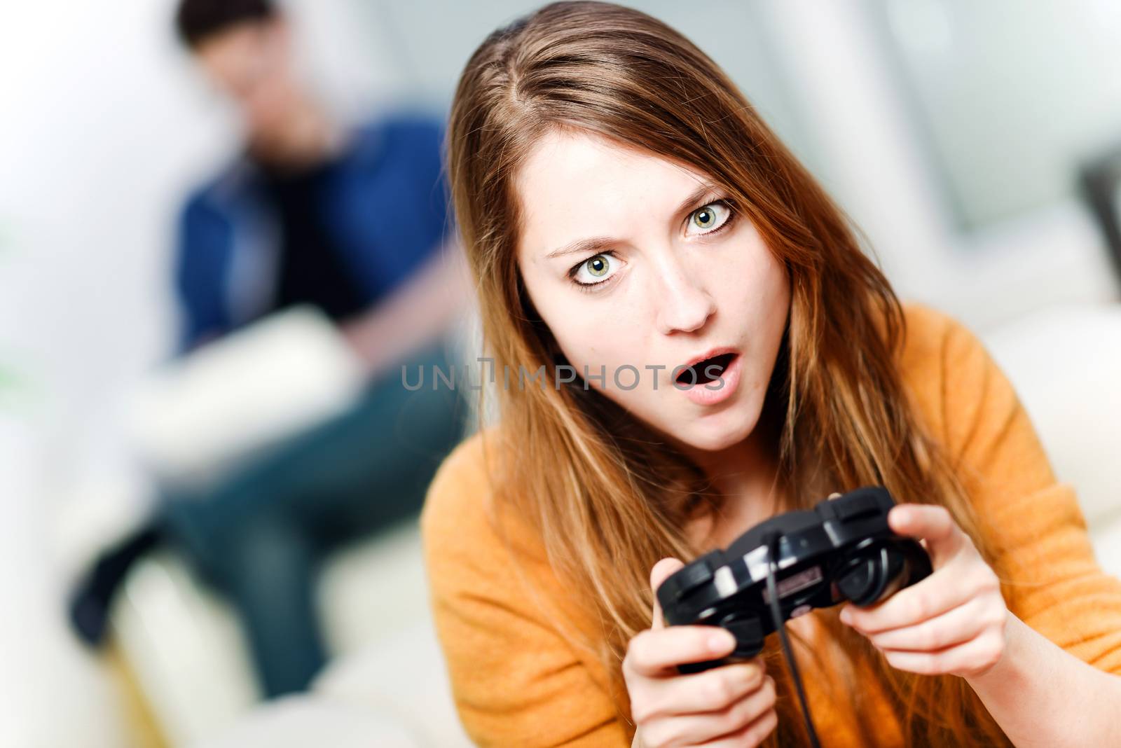 Portrait of beautiful woman playing videogame at home