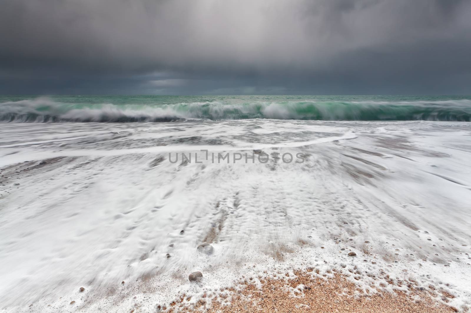 ocean waveson sand beach during storm by catolla